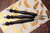 WollLolli Momi DeLuxe aus schwarzem Ebenholz mit BlümchenkeramikPerle, NS 4,5 Knit Pro